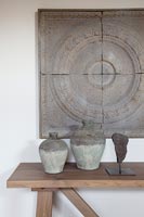 Plaque de pierre sur le mur avec des pots en terre cuite sur table en bois